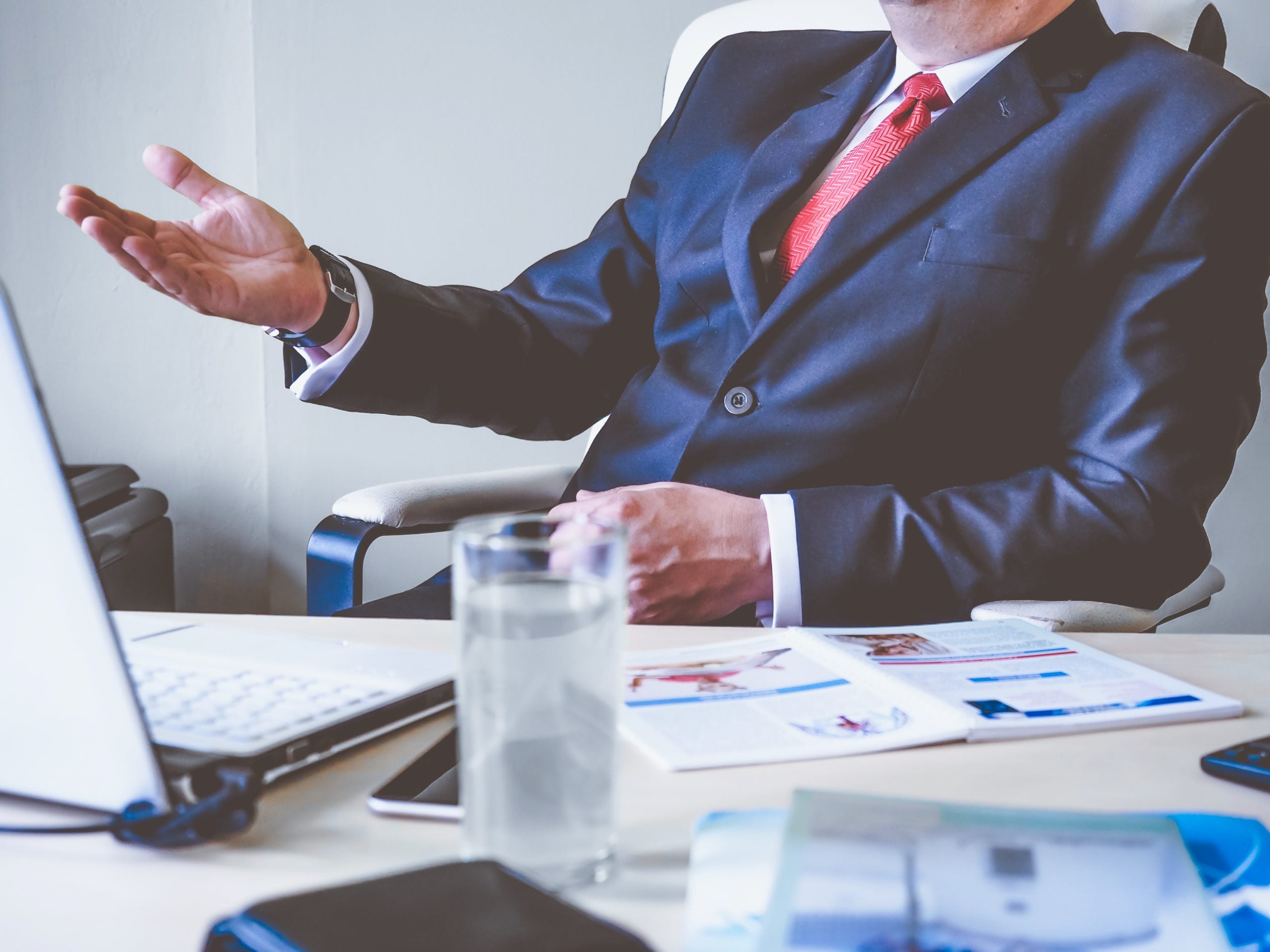 Businessperson gesturing during meeting