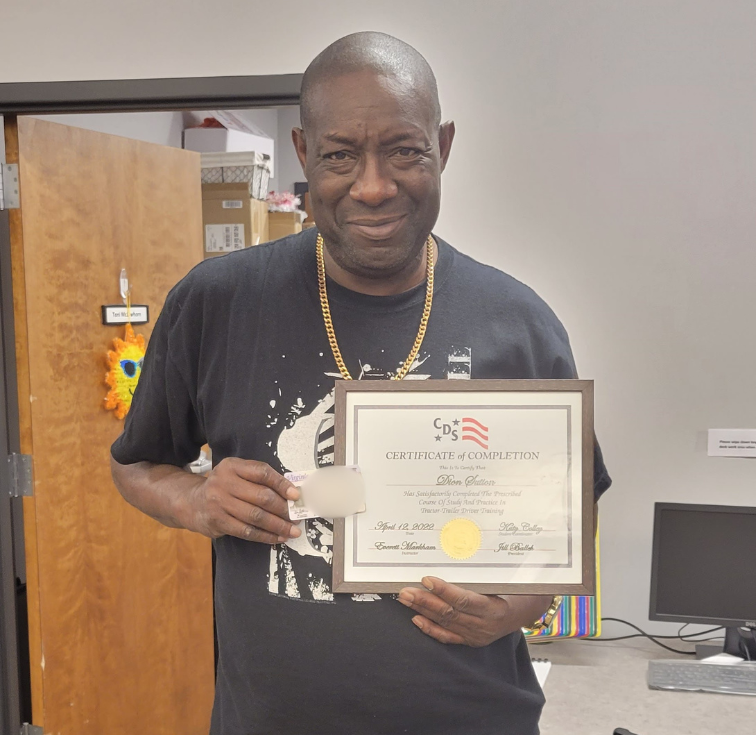 Man holding certificate indoors